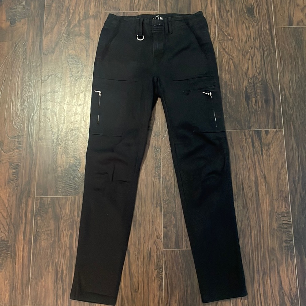 Black crop pants with silver buttons and details.